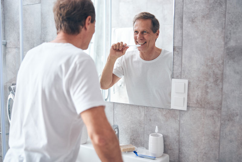 dental patient brushing teeth at home