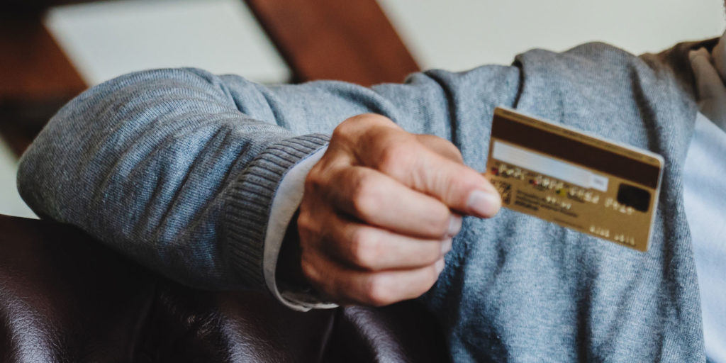 patient with bank card inhand_to pay for dental implants